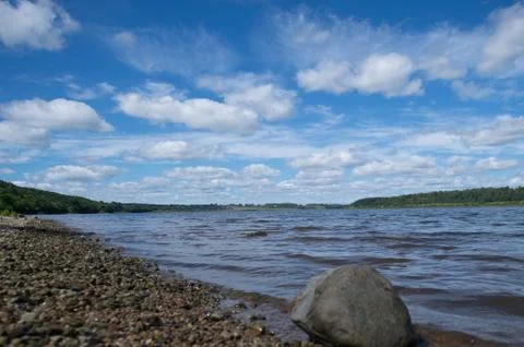 Cloudy sky over the river Stock Photos