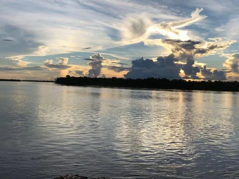 Cloudy Sky Over the River Fotos de archivo