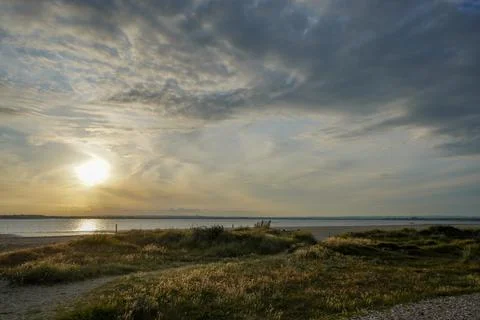 Cloudy sky over a sandy ocean shoreline 写真素材