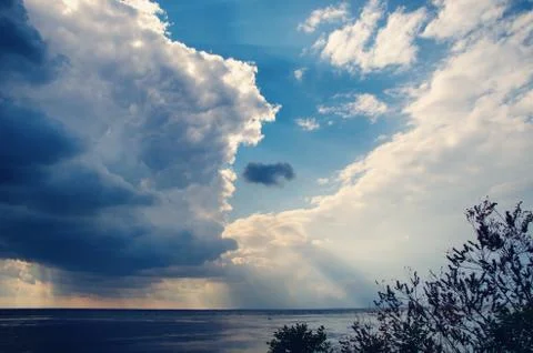 Cloudy sky over the sea Stock Photos