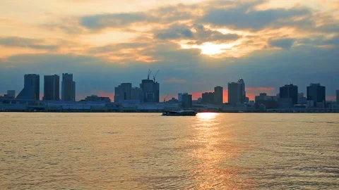 Cloudy sky over skyscrapers at sunset, Odaiba, Tokyo, Japan. Stock Footage 79207115
