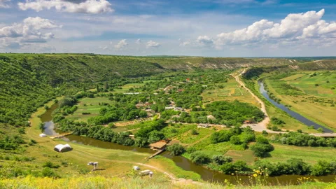 Cloudy Sky over A Valley With A River Stock Footage 117798209