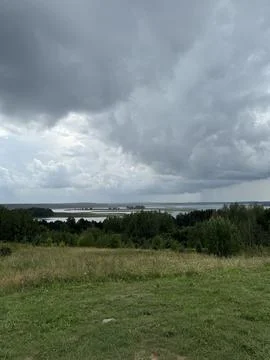 Cloudy Sky Overlooking a Calm Lakeside Landscape Stock Photos