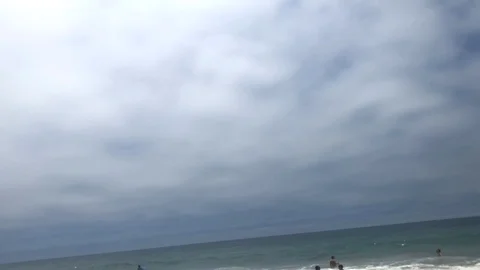 Cloudy sky with pan down to Pacific Ocean and Santa Monica beach Stock Footage 96223749