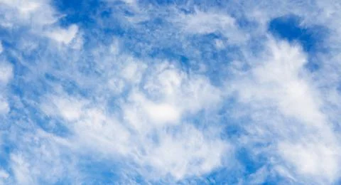 Cloudy sky as pattern or background. White clouds and blue sky. Stock Photos