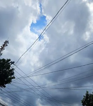 Cloudy sky with power lines Stock Photos