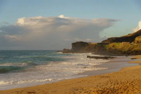 A cloudy sky provides the setting for a beach landscape Stock Photos