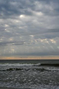 Cloudy sky with rays of sunlight breaking through the clouds. 库存照片