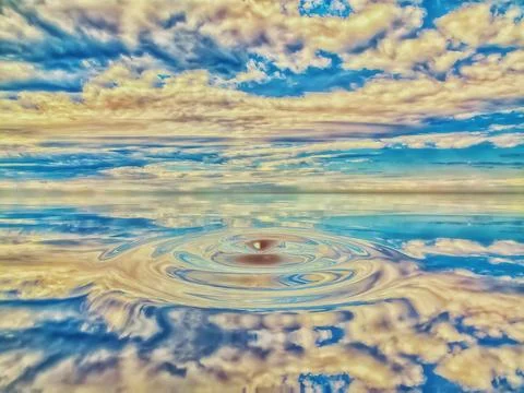 Cloudy sky reflected on ripples in water Stock Photos