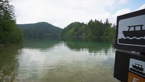Cloudy sky reflecting on emerald water at Plitvice Stock Footage 319764391