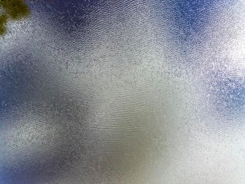 Cloudy sky reflects on lake surface with fine ripples, aerial view Фото