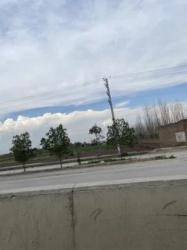 Cloudy sky from road side. Stock Photos
