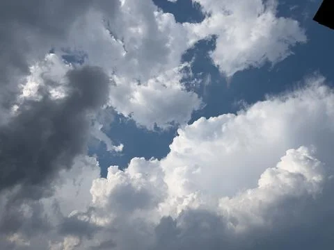 Cloudy sky showing different cloud formations and blue patches Stock Photos