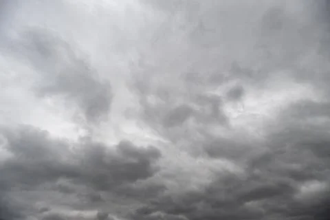 Cloudy sky showing textured dramatic layers, soft light filtering through thi Stock Photos