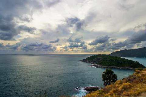 Cloudy sky with small island and brown grass in Phuket Stock Photos
