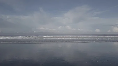 CLOUDY SKY, SMALL WAVES BREAKING ON SHORE | EXT, AERIAL | 2398 | 4K Stock Footage 105192140