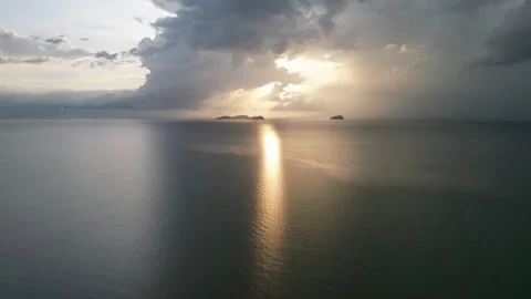 A cloudy sky with a sun in the background. Aerial view Yan, Kedah Vidéo 325823525