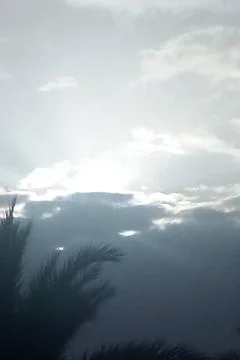 Cloudy sky with sunlight filtering through heavy clouds, Stock Photos