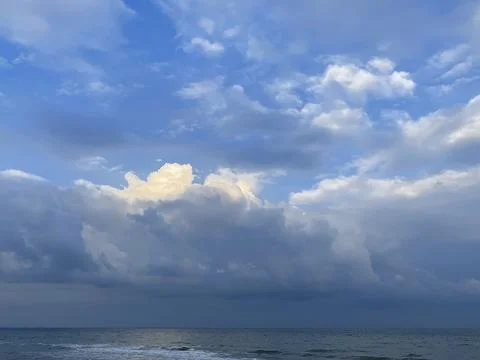 Cloudy sky with sunlight over ocean Stock Photos