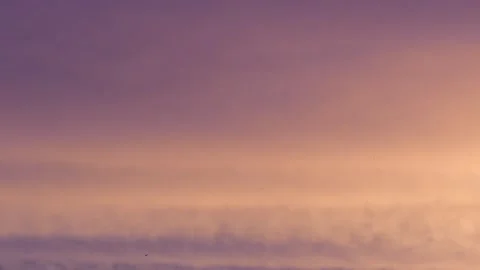 Cloudy sky at sunrise with flying birds - natural sky background - real time Stock Footage 147078079