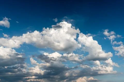 Cloudy sky before a sunset over blue sky Stock Photos