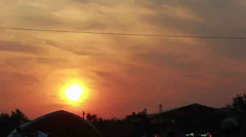 Cloudy sky sunset with people walking by Stock-Footage 26050899