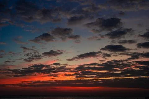Cloudy sky in a sunset at sea Stock Photos