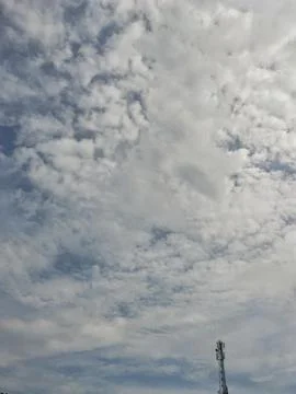 Cloudy Sky with Telecommunication Tower Stock Photos