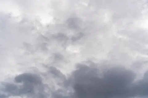 Cloudy sky with various shades of gray and white clouds creating a dynamic Stock Photos