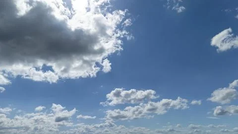 Cloudy sky with a vibrant blue background showcases dynamic white clouds, Foto stock