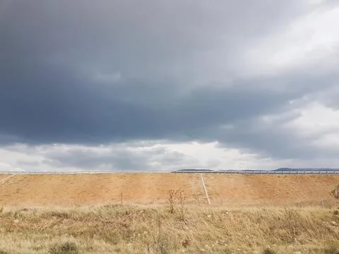Cloudy sky view with a highway at background Stock Photos