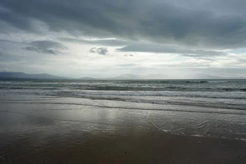 Cloudy Sky, Waves, Wet Sand On Llanddwyn Beach, Anglesey, North Wales Stock Photos