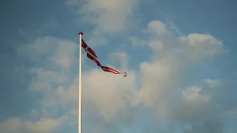 Cloudy Sky With Waving Flag. Gentle Evening Light Illuminates Waving Red Ribbon Stock Footage 345500099