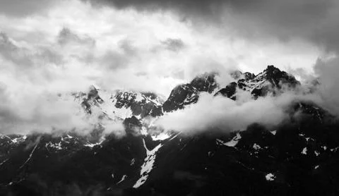 Cloudy Snowy Mountain Range Panorama in Monochrome Stock Photos