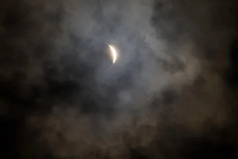 Cloudy solar eclipse Stock Photos