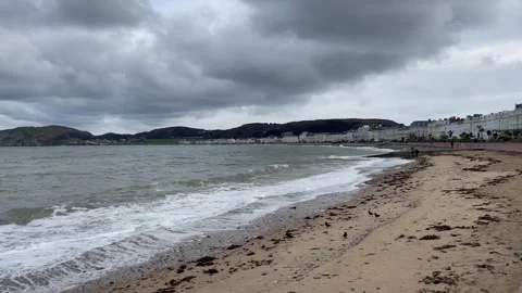 Cloudy stormy day waves beach seaside town houses 191124 Stock Footage 297084796
