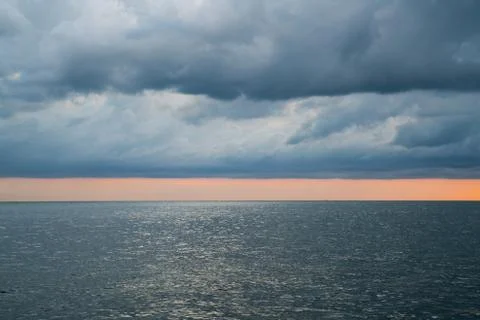 Cloudy stormy dramatic sky over the sea Stock Photos