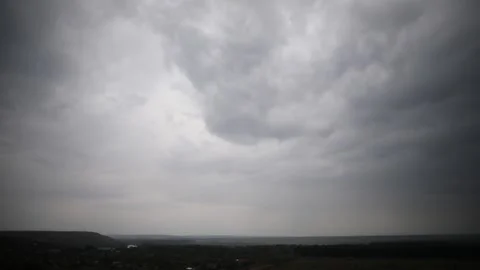 On the cloudy summer sky comes the rain Stock Footage 131116100