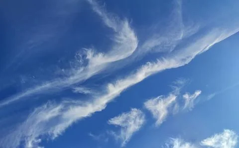 Cloudy summer sky landscape with light feathery clouds in the blue firmament. Stock Photos