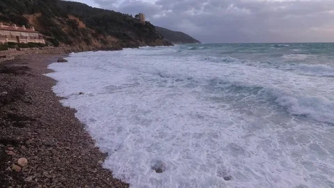 Cloudy sunrise, Rough Sea with white foam and waves in a rocky bay Stock Footage 102066086