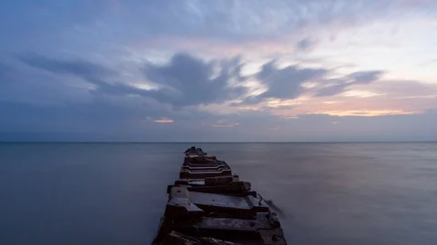Cloudy sunrise time lapse at a stone pier In Milwaukee Stock Footage 98800396