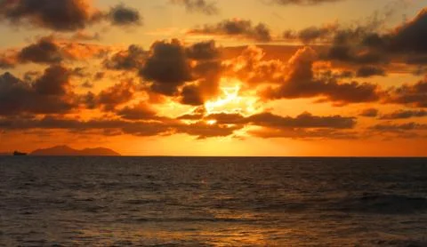Cloudy sunset at beach Stock Photos