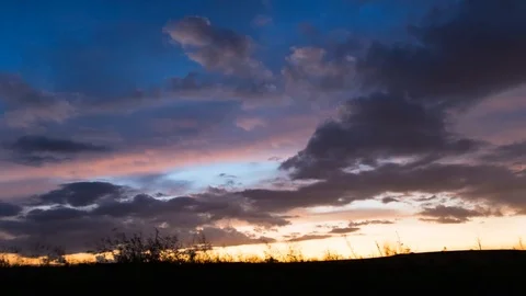 Cloudy Sunset With Beutiful Colours and Grass Sillhoutte in Foregound Stock-Footage 88554098
