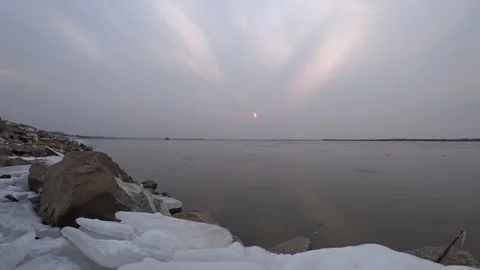 Cloudy sunset on the big river, ice drift on the river Stock Footage 146696282