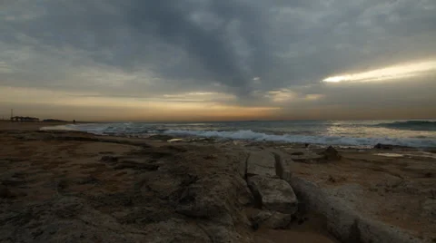 Cloudy Sunset on a chilly, rocky shorline Stock Footage 34369194
