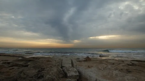 Cloudy Sunset on a chilly, rocky shorline Stock Footage 34369933