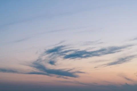 Cloudy sunset with clouds in the wind Stock Photos