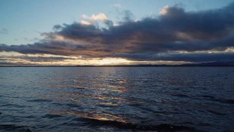 Cloudy sunset on the lake. Beautiful clouds in the sky. Stock Footage 255375032