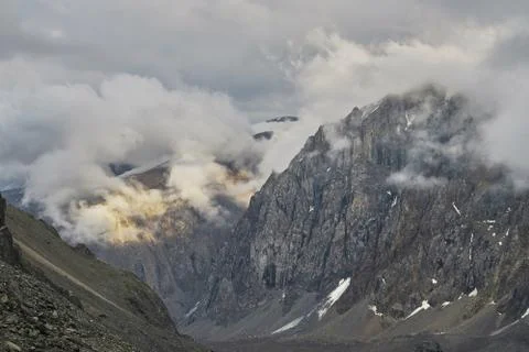 Cloudy sunset in the mountains Stock Photos
