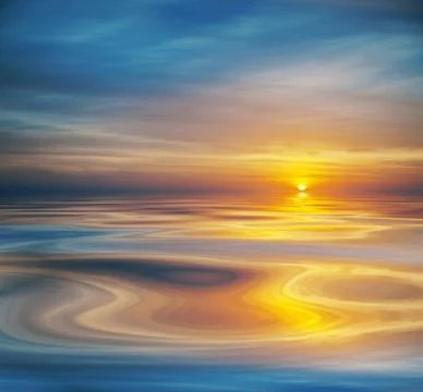 Cloudy sunset or sunrise reflected on calm water Stock Photos